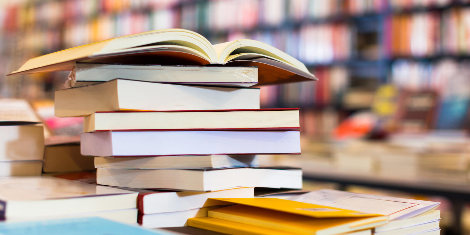 Books and research materials stacked on a desk.